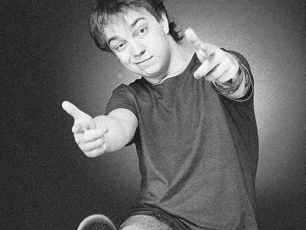 Person meditating with focus on a singular point of cyan light.